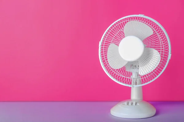 Electric fan on pink background