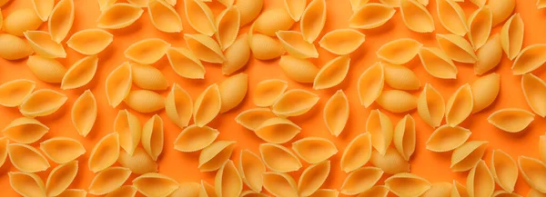 Uncooked Conchiglioni Pasta Orange Background — Stock Photo, Image
