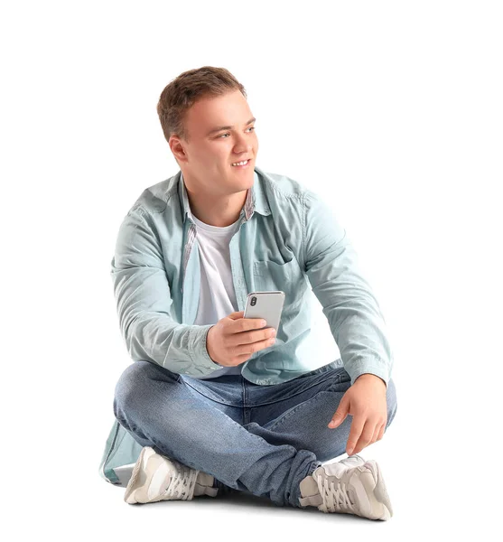 Jovem Com Smartphone Sentado Fundo Branco — Fotografia de Stock