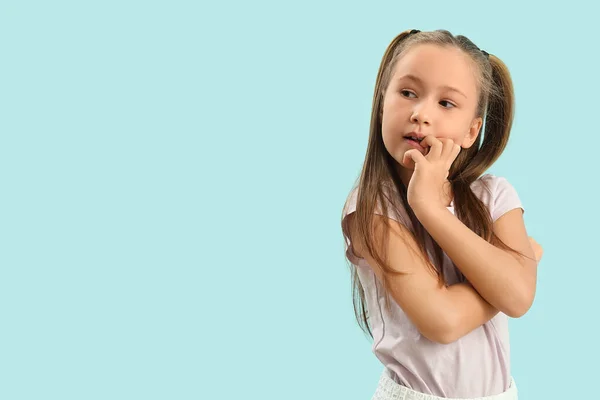 Little Girl Biting Nails Blue Background — Fotografia de Stock