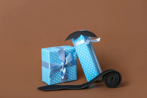 Beautiful gifts for Father\'s Day celebration and tie on color background