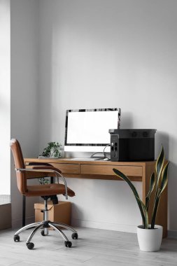 Workplace with computer and portable power station in office