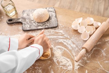 Kadın aşçı mutfakta makarna için hamur hazırlıyor, yakın plan.