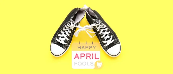 Paper Text Happy April Fools Sneakers Tied Laces Yellow Background — Stock Photo, Image