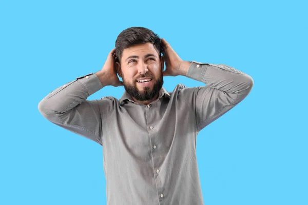 Young Man Suffering Loud Noise Blue Background — Stock Photo, Image