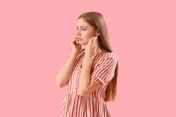 Young Woman Ear Plugs Suffering Loud Noise Pink Background — Stok fotoğraf