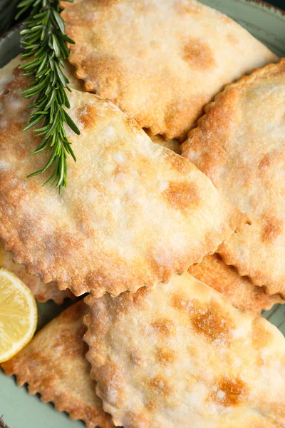 stock image Plate with baked meat empanadas and rosemary, closeup