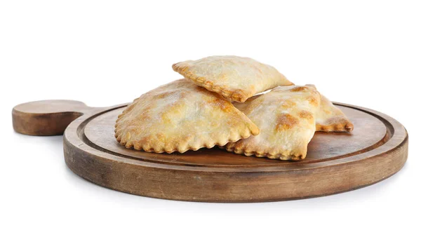 stock image Wooden cutting board with baked meat empanadas on white background