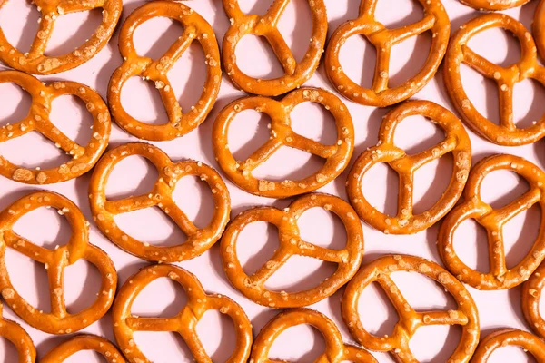 Composition Tasty Salted Pretzels Pink Background Closeup — Stock Photo, Image