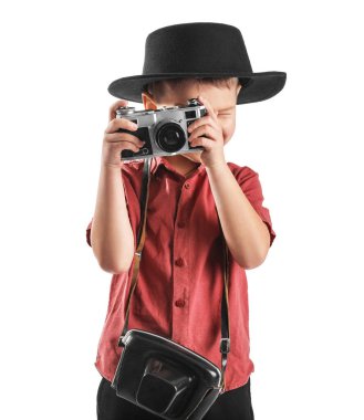 Cute little photographer with camera on white background