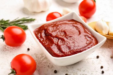 Beyaz grunge arka planda bir kase lezzetli domates ezmesi