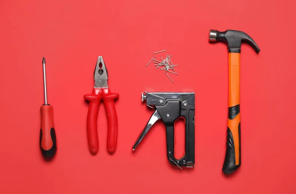 Screwdriver Pliers Building Stapler Hammer Red Background — Stock Photo, Image