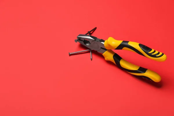 Pliers Nails Red Background — Stock Photo, Image