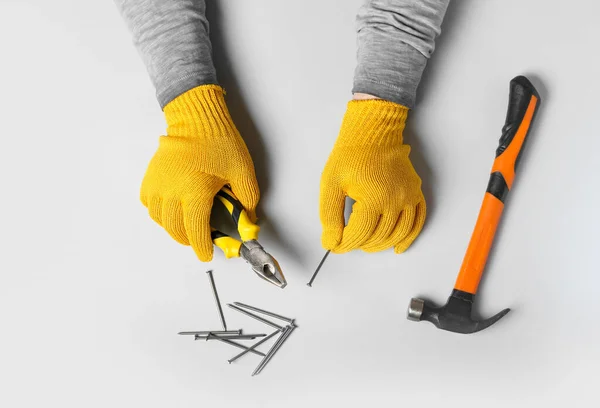 Male Hands Gloves Holding Pliers Nail White Background — Stock Photo, Image