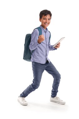 Happy little schoolboy with tablet computer on white background