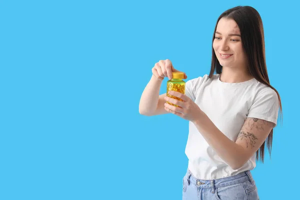 Young Woman Bottle Vitamin Supplements Blue Background — стоковое фото