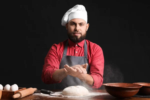 Male Baker Sprinkling Dough Flour Table Dark Background — Stock Photo, Image