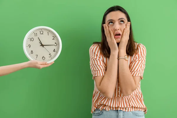Stressed Young Woman Wristwatch Wall Clock Green Background — Stock Photo, Image