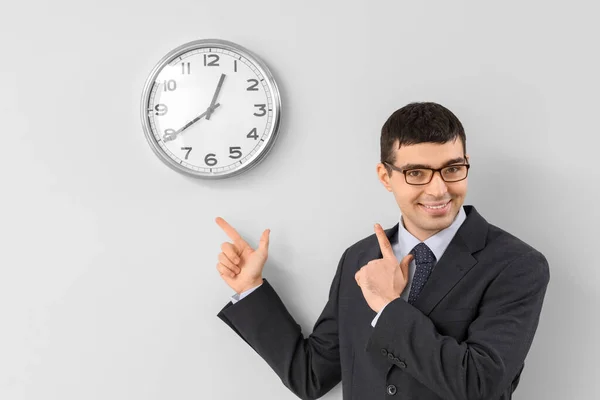 Young Businessman Pointing Clock Light Wall — Stock Photo, Image