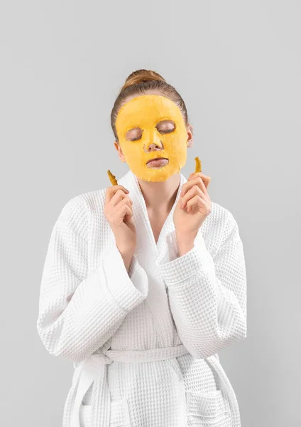 Young Woman Bathrobe Turmeric Sheet Mask Roots Grey Background — Stockfoto