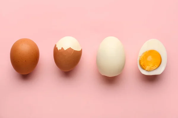Delicious boiled eggs on pink background