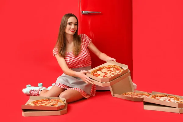 Young Woman Roller Skates Tasty Pizza Fridge Red Background — Zdjęcie stockowe