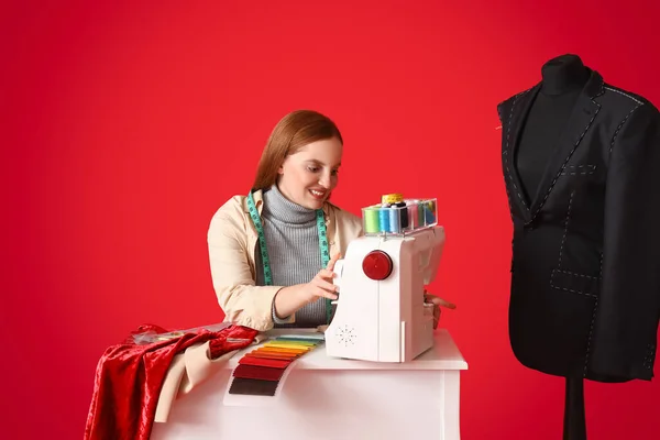 Female Dressmaker Sewing Table Red Background — Stock Photo, Image