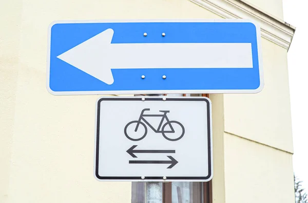 View of Arrow Left and Bike Path signs in city, closeup
