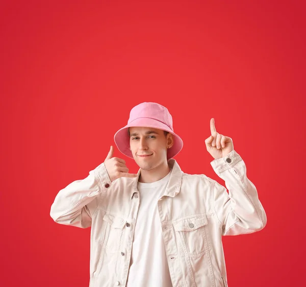 Cool Young Man Showing Call Gesture Pointing Something Red Background — Stock Photo, Image