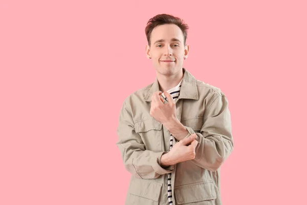 Young Man Rolling His Sleeve Pink Background — Stock Fotó