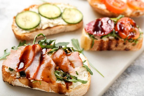 stock image Board with delicious sandwiches, closeup