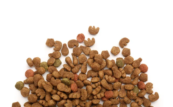 Heap of dry pet food isolated on white background, closeup