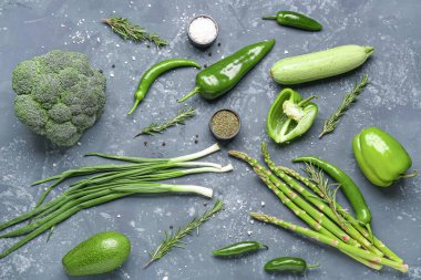 Gri grunge arka planda farklı yeşil sebzeli kompozisyon