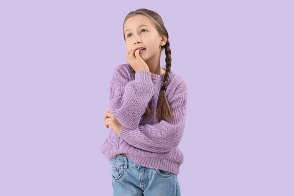 Little Girl Biting Nails Lilac Background — Zdjęcie stockowe