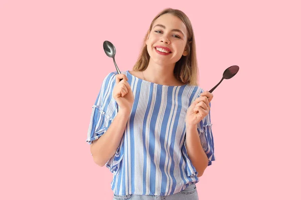 Young Woman Spoons Pink Background — Stock fotografie