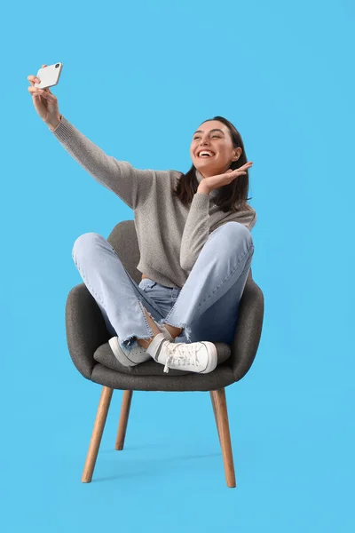 Young Woman Taking Selfie Black Armchair Blue Background — Stock Photo, Image
