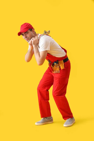 Junger Klempner Mit Schraubenschlüssel Auf Gelbem Hintergrund — Stockfoto