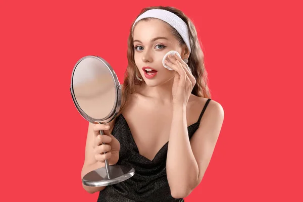 Young Woman Mirror Removing Makeup Red Background — Stock Photo, Image