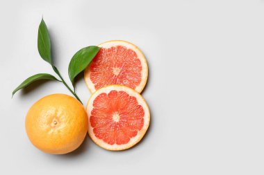 Olgun greyfurtlar ve arka planda bitki dalları