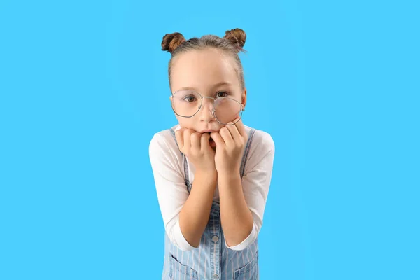 Stressed Little Girl Biting Nails Blue Background — Stockfoto