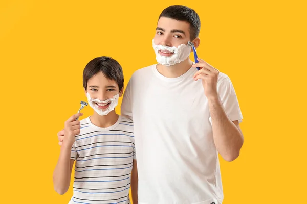 Man His Little Son Shaving Yellow Background — Stock Photo, Image