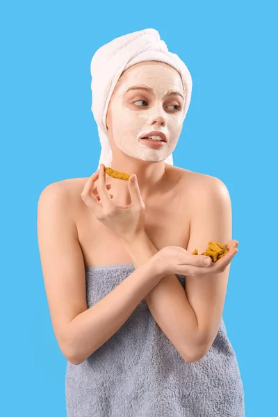 Young Woman Applied Turmeric Mask Roots Blue Background — Stock Photo, Image