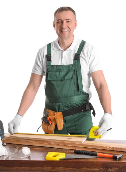 Mature Carpenter Measuring Wooden Plank Table White Background — Stock Photo, Image