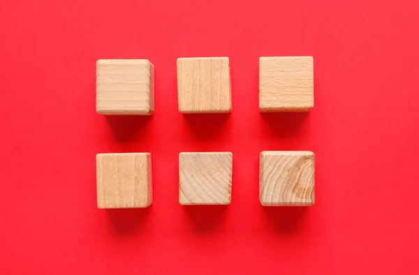 Wooden cubes with check marks on red background
