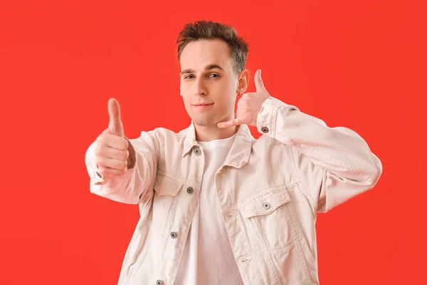 Cool Young Man Showing Call Thumb Gesture Red Background — Stockfoto