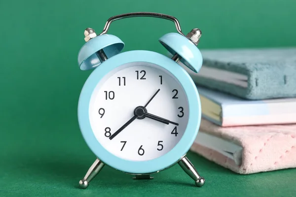 Alarm Clock Notebooks Green Background Closeup — Stock Photo, Image