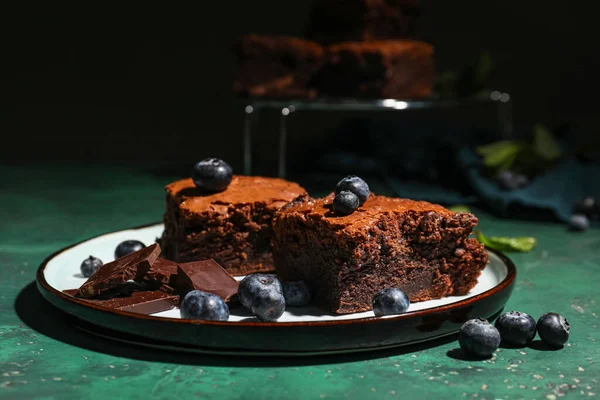 stock image Plate with pieces of tasty chocolate brownie on table