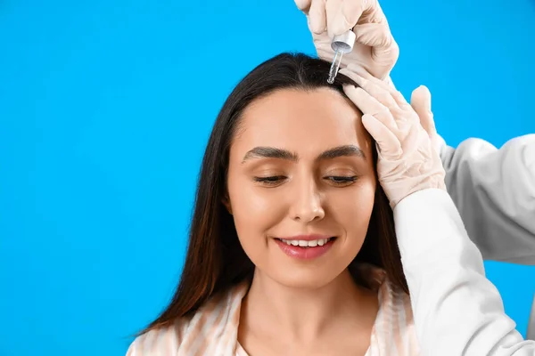 Cosmetologist Applying Serum Woman Hair Blue Background — Stock Photo, Image
