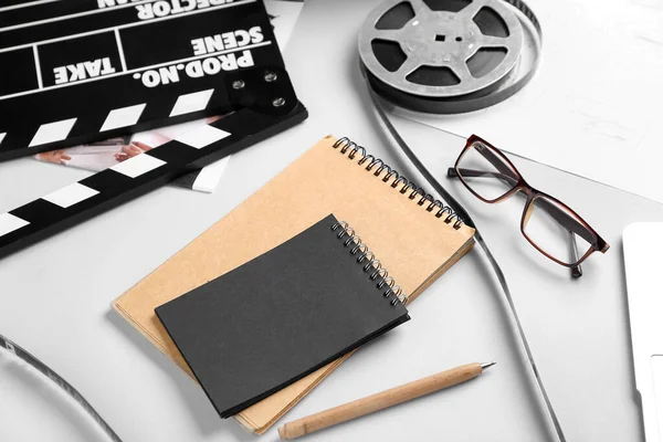 Notebooks Film Reel Movie Clapper Grey Background Closeup — Stock Photo, Image