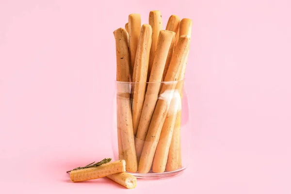 stock image Jar with tasty Italian Grissini on pink background